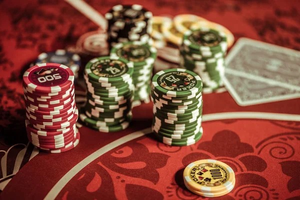 Live poker table with professional dealer and multiple players in broadcast studio